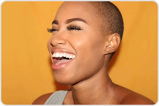 Woman with a bright and healthy smile as a result of using the Curaprox 1560 toothbrush.